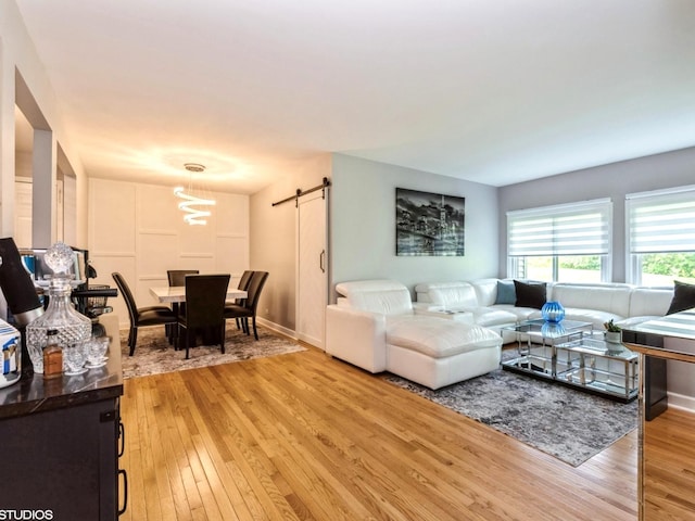 1022 Pinetree Cir N Unit 1022, Buffalo Grove, IL 60089 - living area with a barn door, light wood-type flooring, and a chandelier