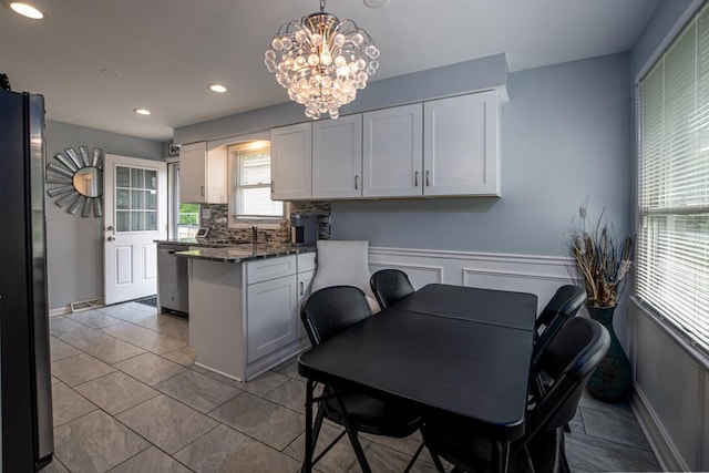 14816 Homan Ave, Midlothian, IL 60445 - tiled dining room with a chandelier, recessed lighting, and wainscoting