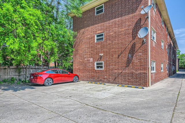 2067 W Farwell Ave Unit 1S, Chicago, IL 60645 - view of home's exterior with brick siding and uncovered parking