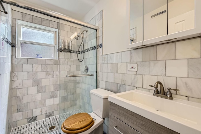 2067 W Farwell Ave Unit 1S, Chicago, IL 60645 - bathroom featuring tile walls, a shower stall, vanity, and backsplash