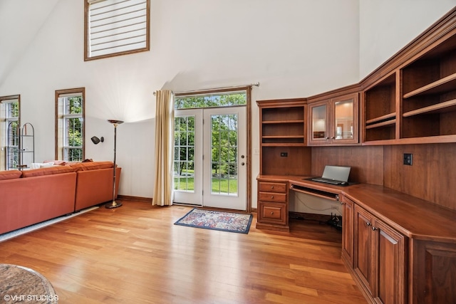 1012 Hickory Dr, Western Springs, IL 60558 - home office with built in desk, a high ceiling, and light wood-type flooring