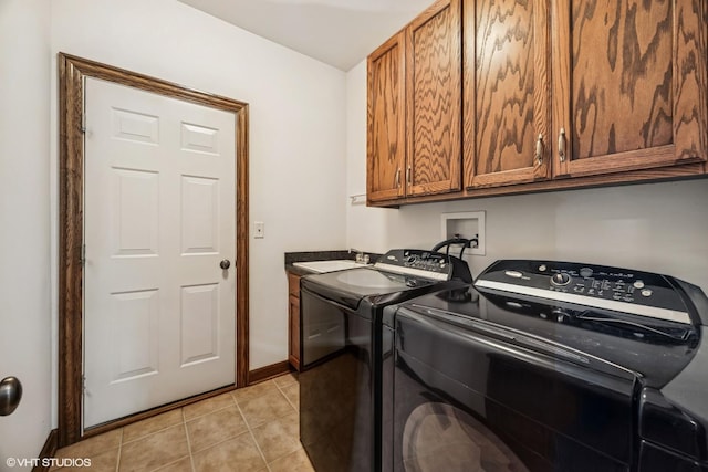 1012 Hickory Dr, Western Springs, IL 60558 - laundry area featuring cabinet space, separate washer and dryer, and light tile patterned floors