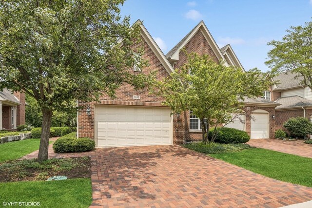 1012 Hickory Dr, Western Springs, IL 60558 - view of front facade with decorative driveway, brick siding, and a front yard