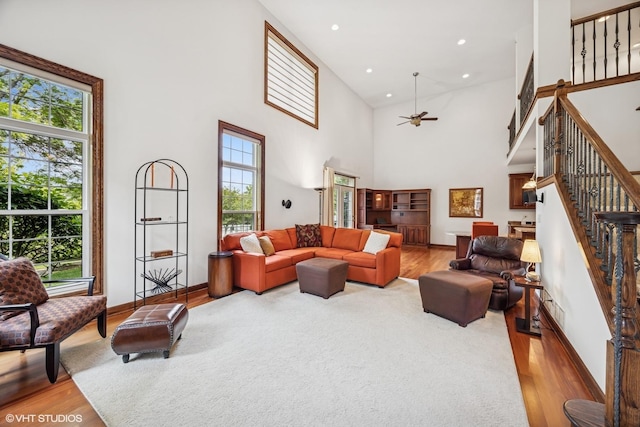 1012 Hickory Dr, Western Springs, IL 60558 - living room featuring light wood-type flooring, a ceiling fan, stairs, a high ceiling, and recessed lighting