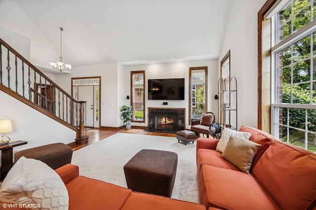 1012 Hickory Dr, Western Springs, IL 60558 - living room with stairs, a chandelier, wood finished floors, a fireplace with flush hearth, and high vaulted ceiling