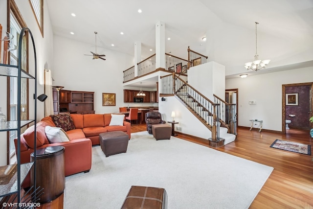 1012 Hickory Dr, Western Springs, IL 60558 - living room with high vaulted ceiling, stairs, wood finished floors, a chandelier, and ceiling fan
