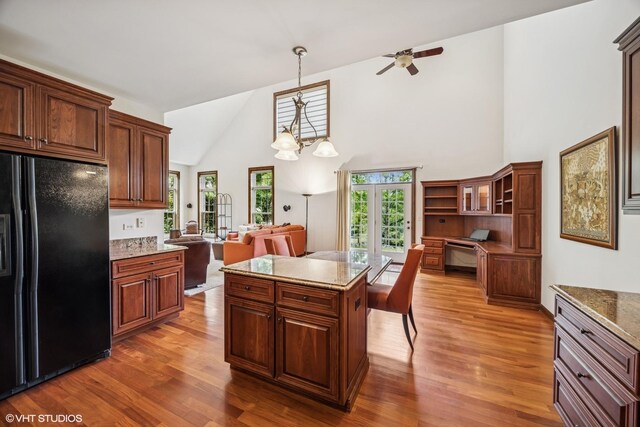 1012 Hickory Dr, Western Springs, IL 60558 - kitchen featuring black fridge, high vaulted ceiling, wood finished floors, a ceiling fan, and decorative light fixtures