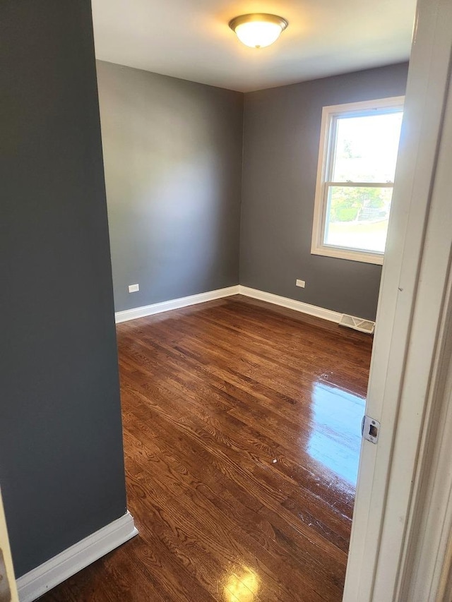 17109 Magnolia Dr, Hazel Crest, IL 60429 - empty room featuring dark wood-style flooring and baseboards