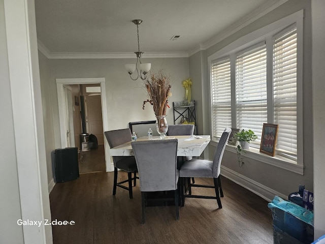 5006 W Crystal St, Chicago, IL 60651 - dining area featuring dark wood-style floors, a chandelier, and crown molding