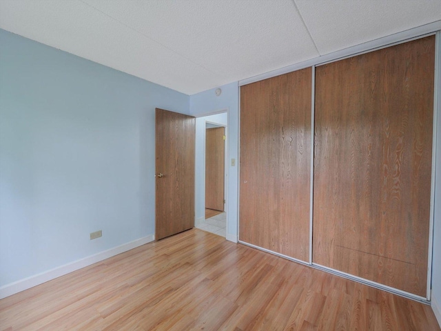 5600 Astor Ln Unit 202, Rolling Meadows, IL 60008 - unfurnished bedroom with wood finished floors and baseboards