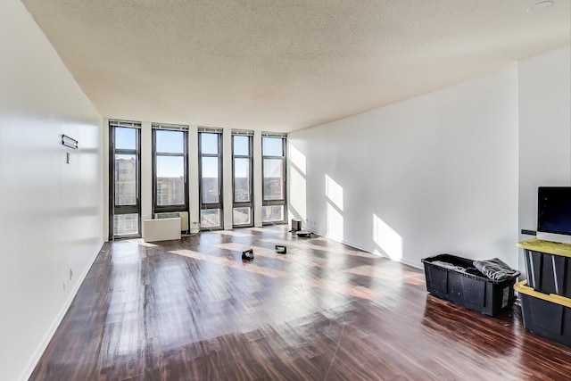 6700 S S Shore Dr Unit 17C, Chicago, IL 60649 - unfurnished living room with wood finished floors, a textured ceiling, and expansive windows