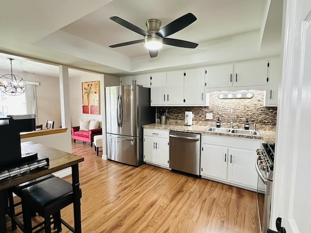 15721 Old Orchard Ct Unit 2S, Orland Park, IL 60462 - kitchen with appliances with stainless steel finishes, backsplash, white cabinetry, and light wood-style floors