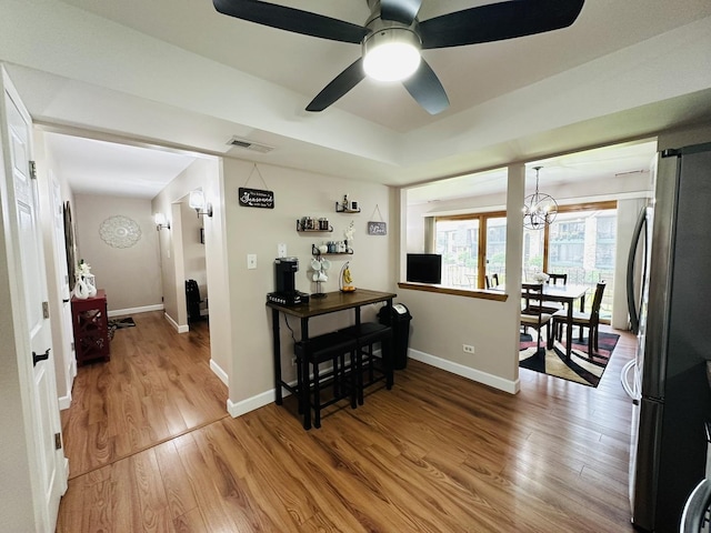 15721 Old Orchard Ct Unit 2S, Orland Park, IL 60462 - dining room featuring wood finished floors, a chandelier, and a ceiling fan