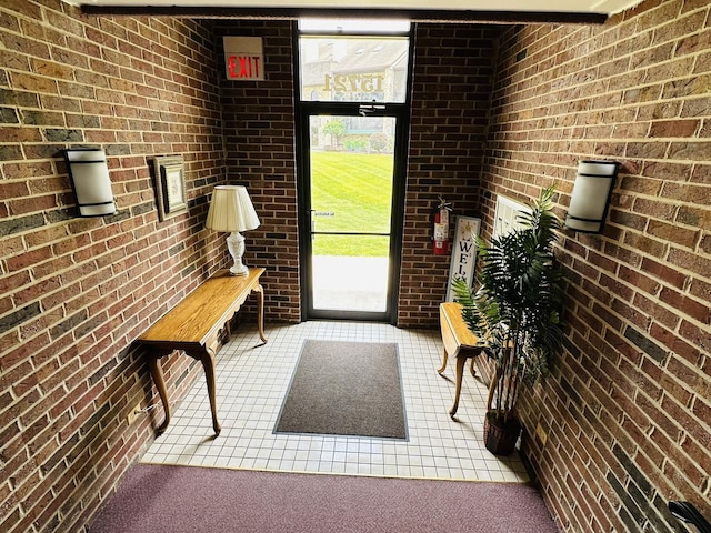 15721 Old Orchard Ct Unit 2S, Orland Park, IL 60462 - doorway to outside with brick wall and tile patterned flooring