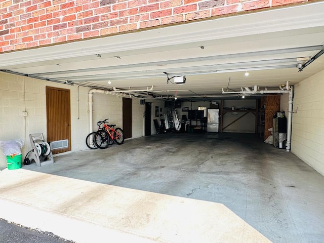 15721 Old Orchard Ct Unit 2S, Orland Park, IL 60462 - garage with a garage door opener and freestanding refrigerator