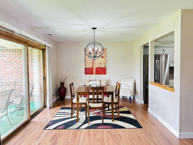 15721 Old Orchard Ct Unit 2S, Orland Park, IL 60462 - dining room featuring healthy amount of natural light, light wood finished floors, and a chandelier