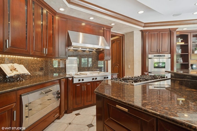 5688 Rosos Pkwy, Long Grove, IL 60047 - kitchen with wall chimney exhaust hood, appliances with stainless steel finishes, backsplash, dark stone counters, and recessed lighting