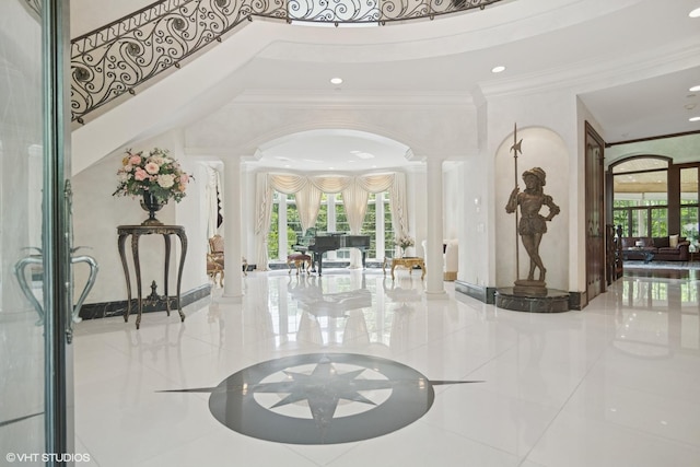 5688 Rosos Pkwy, Long Grove, IL 60047 - entrance foyer featuring decorative columns, ornamental molding, a high ceiling, healthy amount of natural light, and arched walkways