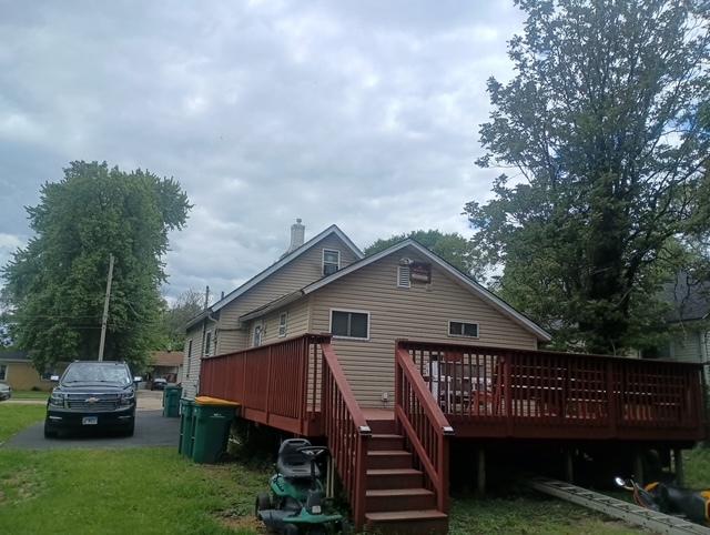 213 Edward St, Joliet, IL 60436 - rear view of house featuring a wooden deck, a chimney, and a lawn
