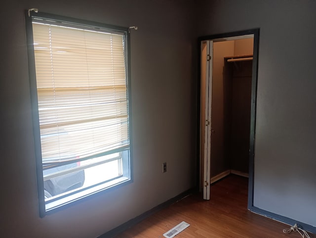 213 Edward St, Joliet, IL 60436 - unfurnished bedroom featuring wood finished floors and baseboards