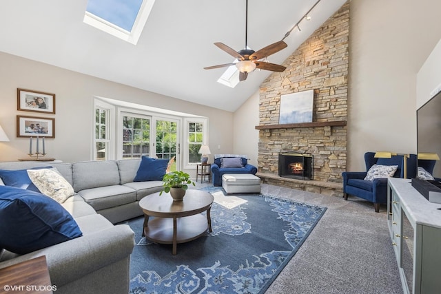 1808 Beloit Ct, Naperville, IL 60565 - living area with high vaulted ceiling, a ceiling fan, a stone fireplace, a skylight, and carpet flooring