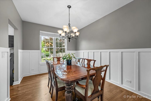 2171 Edinburgh Ln, Aurora, IL 60504 - dining space featuring a decorative wall, a chandelier, wood finished floors, and a wainscoted wall