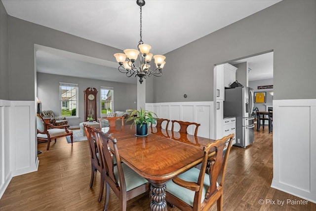 2171 Edinburgh Ln, Aurora, IL 60504 - dining area with a chandelier, a wainscoted wall, a decorative wall, and dark wood-type flooring