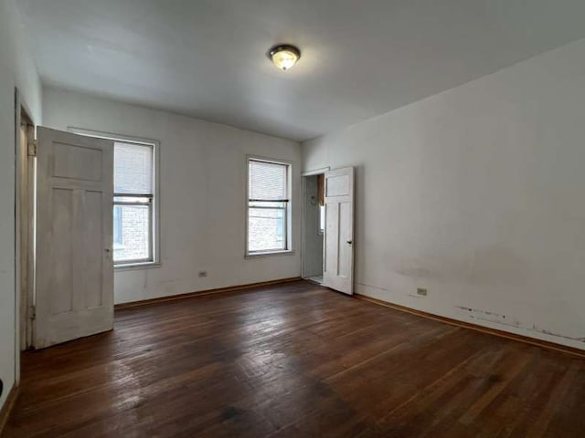 1059 E Hyde Park Blvd Unit 1, Chicago, IL 60615 - unfurnished bedroom with baseboards and dark wood finished floors