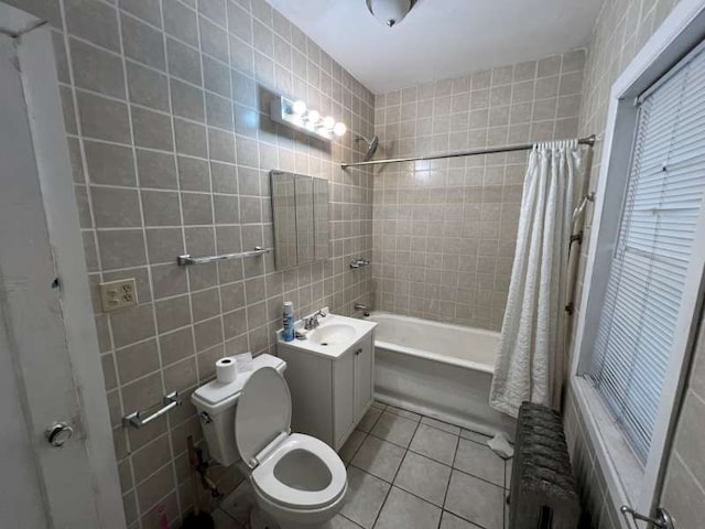 1059 E Hyde Park Blvd Unit 1, Chicago, IL 60615 - full bathroom featuring radiator heating unit, shower / bath combination with curtain, tile patterned flooring, tile walls, and vanity