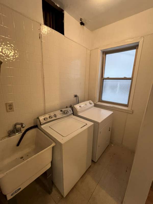 1059 E Hyde Park Blvd Unit 1, Chicago, IL 60615 - washroom featuring washer and dryer and light tile patterned flooring