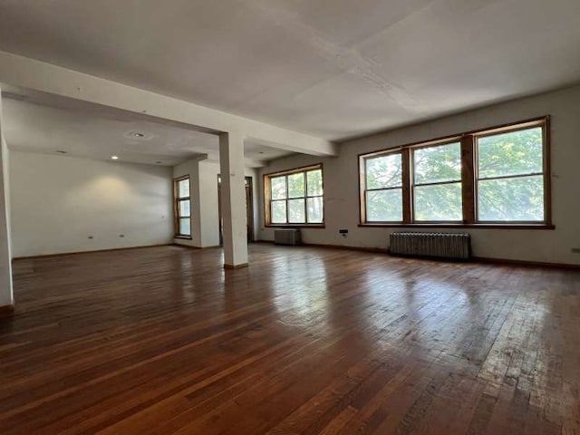 1059 E Hyde Park Blvd Unit 1, Chicago, IL 60615 - unfurnished living room featuring radiator heating unit and dark wood finished floors