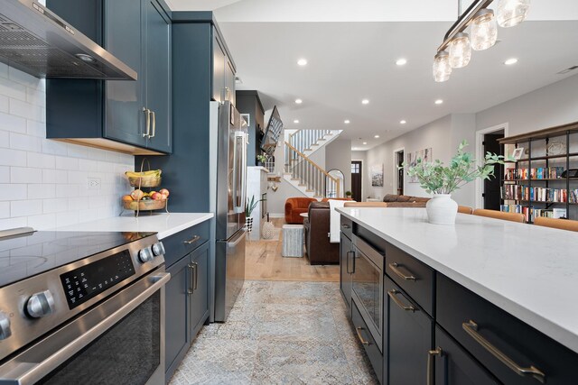 7929 N Octavia Ave, Niles, IL 60714 - kitchen featuring stainless steel appliances, exhaust hood, light countertops, recessed lighting, and open floor plan