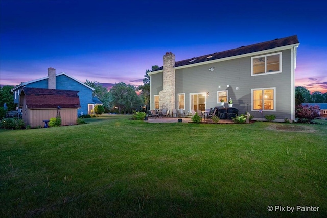 1714 Tall Tree Ln, Johnsburg, IL 60051 - rear view of house featuring a patio, a yard, a chimney, and a storage shed