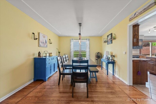 1714 Tall Tree Ln, Johnsburg, IL 60051 - dining area featuring light wood-style flooring and baseboards