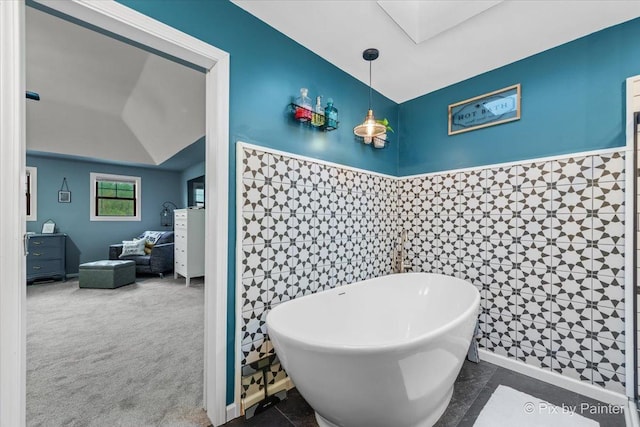1714 Tall Tree Ln, Johnsburg, IL 60051 - bathroom with a freestanding bath, a skylight, tile walls, wainscoting, and vanity