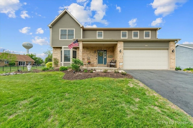 1714 Tall Tree Ln, Johnsburg, IL 60051 - view of front facade with brick siding, a garage, and asphalt driveway