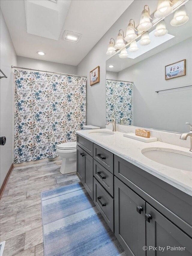 1714 Tall Tree Ln, Johnsburg, IL 60051 - bathroom with double vanity, wood finished floors, a shower with curtain, and recessed lighting