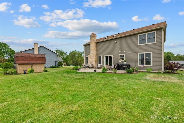 1714 Tall Tree Ln, Johnsburg, IL 60051 - back of house featuring a patio area, a lawn, a shed, and a chimney