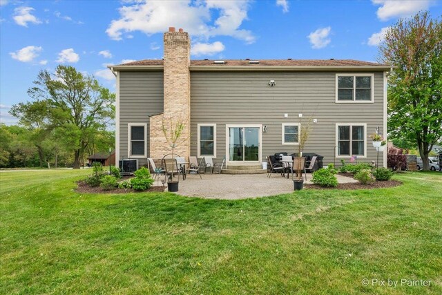 1714 Tall Tree Ln, Johnsburg, IL 60051 - rear view of property with a chimney, a yard, and a patio area