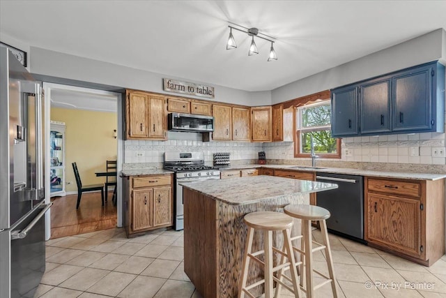 1714 Tall Tree Ln, Johnsburg, IL 60051 - kitchen featuring stainless steel appliances, light tile patterned flooring, backsplash, a kitchen island, and a kitchen breakfast bar