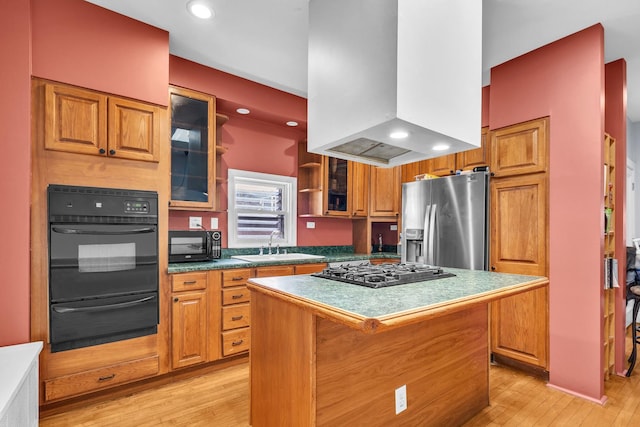 1027 N Harlem Ave, Oak Park, IL 60302 - kitchen with black appliances, a warming drawer, wall chimney range hood, light wood-type flooring, and brown cabinetry