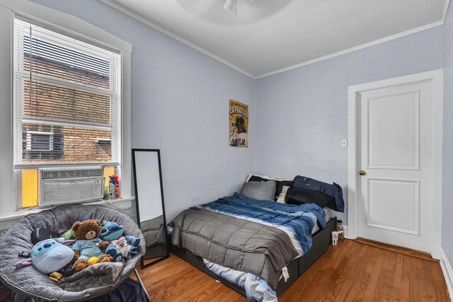1027 N Harlem Ave, Oak Park, IL 60302 - bedroom with wood finished floors, crown molding, cooling unit, and ceiling fan
