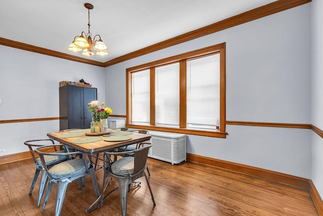 1027 N Harlem Ave, Oak Park, IL 60302 - dining area featuring radiator heating unit, wood-type flooring, a chandelier, and ornamental molding