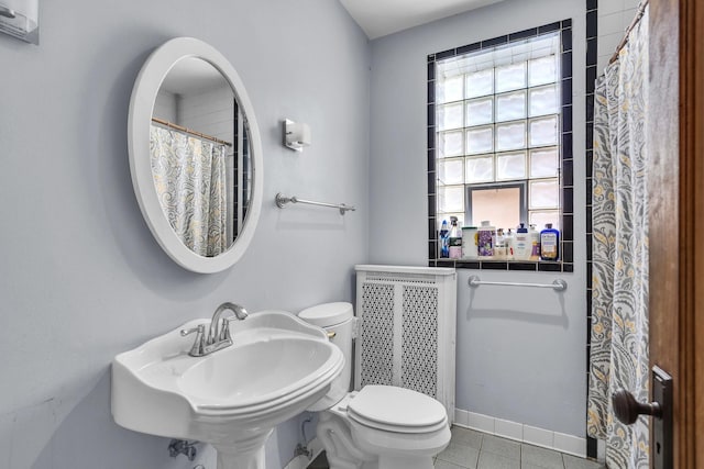 1027 N Harlem Ave, Oak Park, IL 60302 - full bathroom with radiator heating unit, healthy amount of natural light, tile patterned flooring, and a shower with curtain