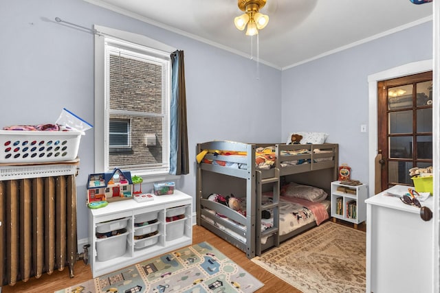 1027 N Harlem Ave, Oak Park, IL 60302 - bedroom with radiator, ornamental molding, wood finished floors, multiple windows, and ceiling fan