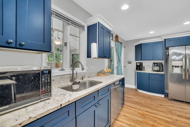 1810 Jana Ln, Morris, IL 60450 - kitchen with stainless steel appliances, blue cabinetry, light wood finished floors, light stone countertops, and recessed lighting