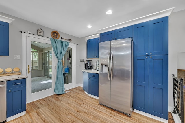 1810 Jana Ln, Morris, IL 60450 - kitchen with appliances with stainless steel finishes, light wood-style floors, blue cabinetry, and recessed lighting