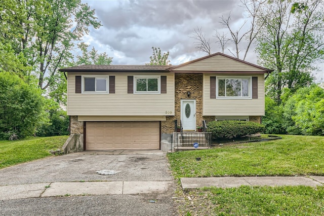 509 Barbara Ct S, University Park, IL 60484 - split foyer home featuring asphalt driveway, brick siding, a garage, and a front lawn
