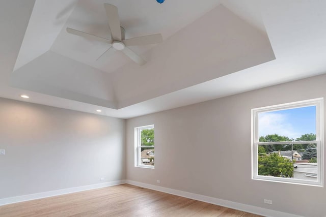 7431 W Forest Preserve Ave, Chicago, IL 60634 - unfurnished room with light wood-style floors, ceiling fan, recessed lighting, and a raised ceiling