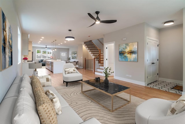 7431 W Forest Preserve Ave, Chicago, IL 60634 - living area with stairs, light wood finished floors, a ceiling fan, and recessed lighting